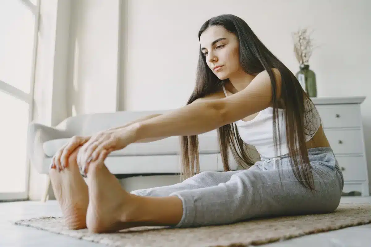Persona che pratica stretching leggero e respira profondamente prima di coricarsi