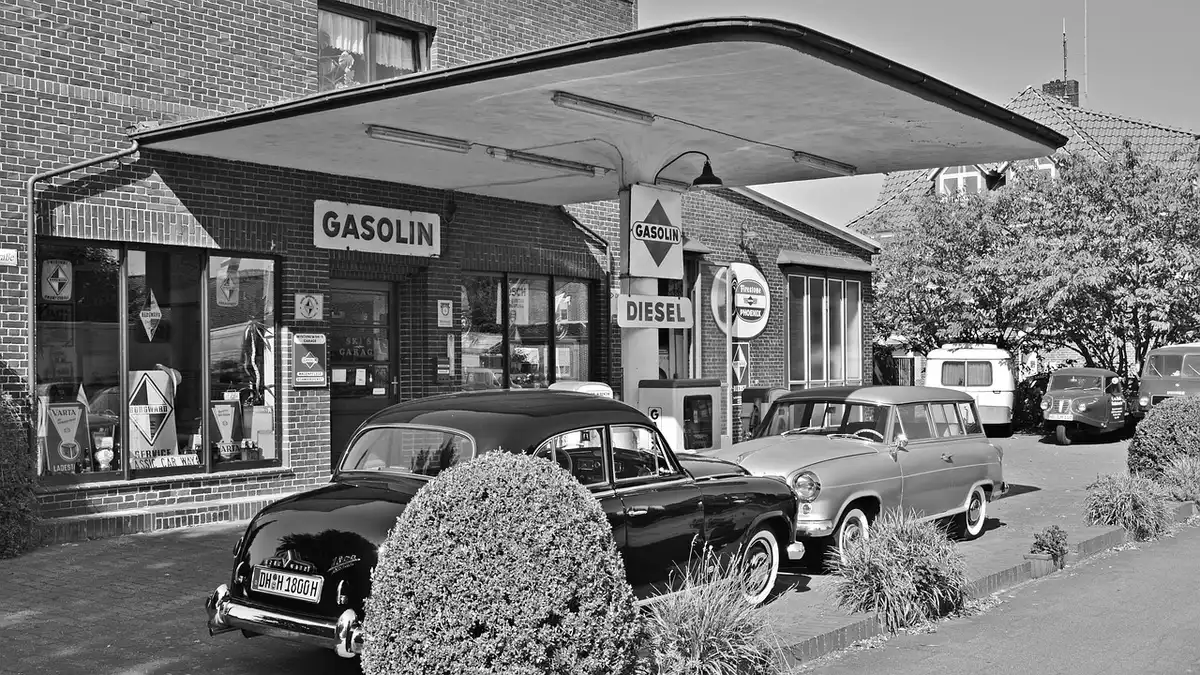 Pompa di benzina con cartello prezzi e una scritta prezzo massimo