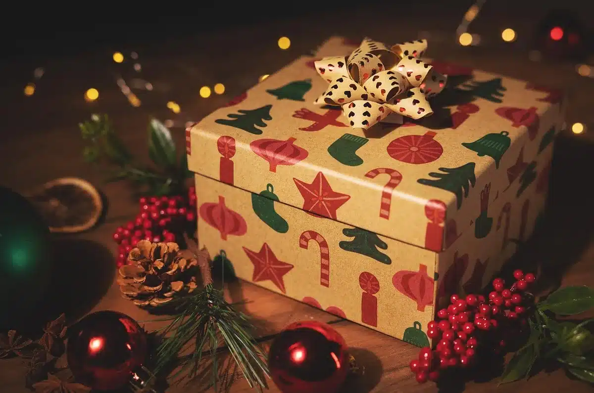 Scatola regalo aperta con collane e bracciali e luci natalizie sfocate sullo sfondo